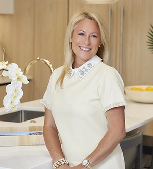 Sales executive standing in a modern luxury condo kitchen interior