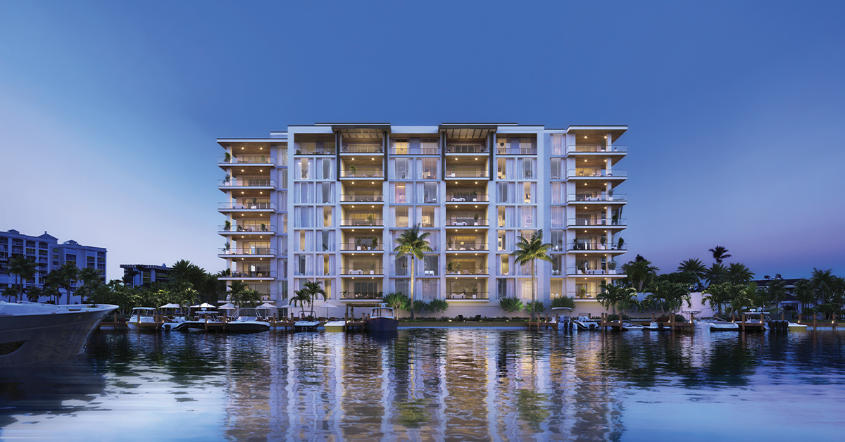 Luxury marina-front residences with docked boats at dusk