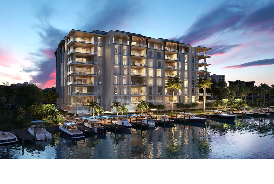 3300 Gulf Shore waterfront building at dusk beside marina boats and palm trees